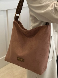 Brown vintage suede hobo bag for women with wide shoulder strap and brand label