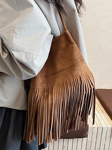 Brown suede shoulder bag with long fringe tassels and minimalist vintage hobo style