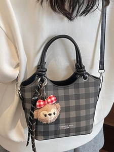 Chic checkered tote bag in grey and black with crossbody strap and plush charm