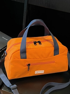 Stylish orange nylon pillow bag with blue straps and adjustable crossbody shoulder strap