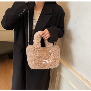 Detail of plush lamb wool tote bag with silver chain strap and spirit free cloth label