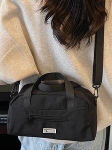 Minimalist black nylon pillow bag for women with JL Fashion logo and dual straps