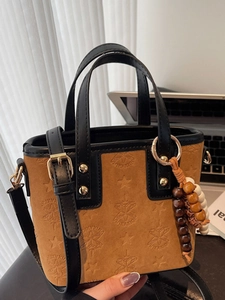 Brown suede French style bucket bag with star embossing and wooden bead charm
