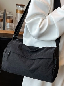 Minimalist black nylon cylinder tote bag with adjustable strap for casual daily commuting