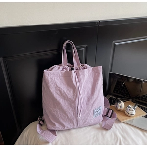Close-up of lightweight lavender drawstring backpack with wrinkled nylon texture
