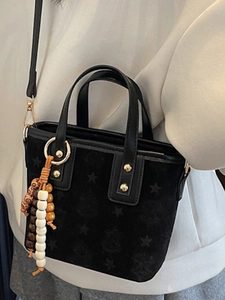 French style black mini tote bag with star embossing and ethnic bead charm