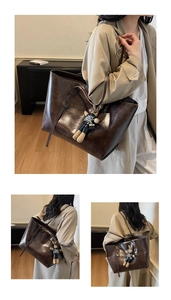 Detail view of dark brown oil wax leather tote bag with a cute rabbit plush pendant accessory