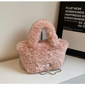 Detail of pink faux fur handbag showing soft texture and silver beaded metal chain