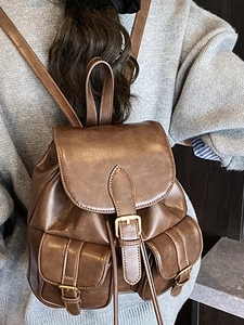 Vintage dark brown faux leather backpack for women with dual front pockets and metal buckles