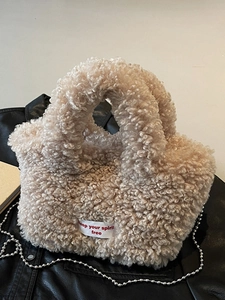Beige faux fur teddy tote bag with twin handles and keep your spirit free woven label