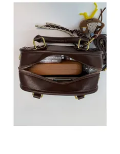 Interior view of vintage brown leather handbag showing spacious capacity and gold hardware