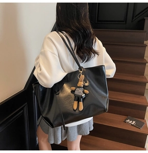 Black large tote bag in glossy faux leather with a cute houndstooth rabbit charm