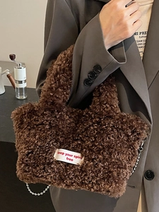 Brown plush faux fur handbag with silver metal chain strap and embroidered label