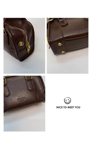Detailed macro view of dark brown leather texture, golden zippers, and metal feet on bag