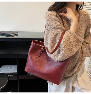 Close-up of wine red tote bag with fashion bag NEW YORK text and leather texture
