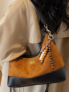 Retro quilted underarm bag in brown suede and black leather with wooden bead charm