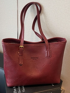 Deep red faux leather tote bag with lychee texture and long shoulder straps for commuting