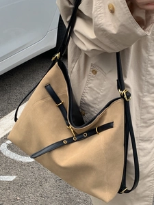Large khaki suede tote bag with black leather straps and gold hardware details