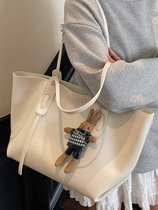 Minimalist white PU leather tote bag with a cute plush rabbit charm on a shoulder strap