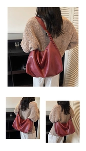 Close-up of a large burgundy hobo shoulder bag with a soft pleated leather texture
