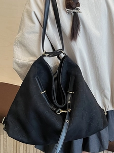 Chic black quilted tote bag with golden metal hardware shown on model shoulder