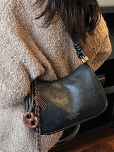 Retro black oversized crescent shoulder bag with pleated texture and decorative charms