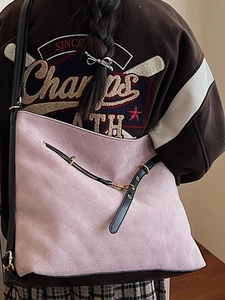 Pink quilted suede tote bag with black leather straps and golden metal hardware details