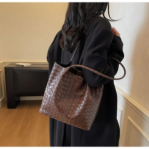 Detailed view of dark brown woven tote bag featuring high-quality faux leather texture