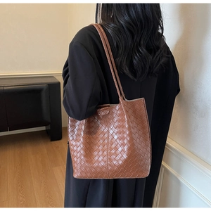Rear view of brown woven leather tote bag showing large capacity and long straps