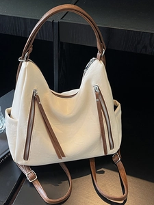 Large cream underarm tote bag with brown straps and dual zipper details for women