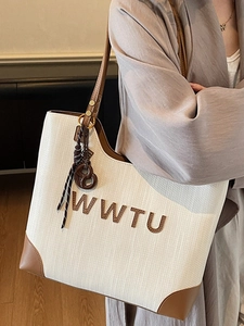 Chic large capacity tote bag featuring white woven texture and brown leather trim