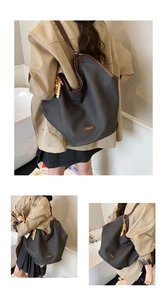 Large capacity tote bag in charcoal grey with brown leather trim and wooden bead charm