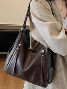 Deep brown large hobo shoulder bag with dual vertical zippers and soft leather texture