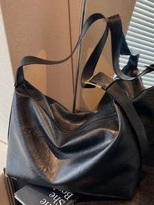 Large black faux leather hobo crossbody bag with adjustable strap and gold metal buckle