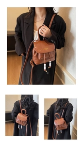 Detail view of vintage brown leather mini backpack with pearl drawstring and metal ring handle