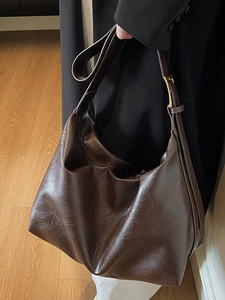 Minimalist large capacity dark brown leather hobo bag with wide shoulder strap and gold hardware