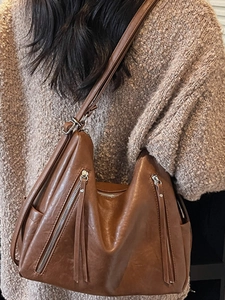 Brown leather hobo bag with tassel and silver zipper for stylish daily commuting
