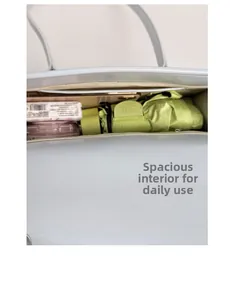 Internal capacity of light blue shoulder bag showing umbrella and daily essentials inside