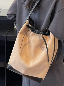 Large khaki suede bucket bag for women with black trim and elegant drawstring detail