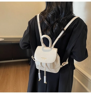 Detail view of mini PU leather backpack with magnetic flap and drawstring closure