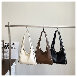 Détails des œillets métalliques sur sacs hobo en similicuir crème, marron et noir