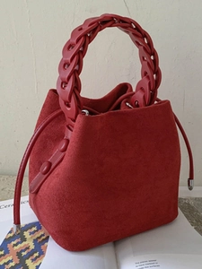 Minimalist red suede bucket bag with stylish chunky chain handle for women in autumn