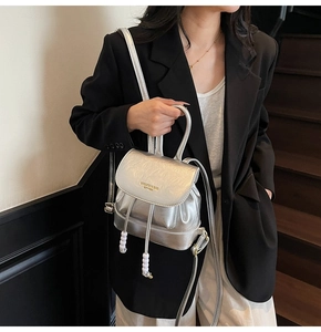 Silver metallic mini backpack with crinkled texture and beaded drawstring detail