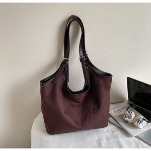 Detail view of large tote bag in dark brown faux suede with adjustable leather strap