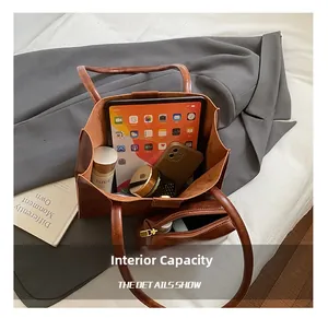 Detailed view of large capacity brown leather tote bag with internal storage for iPad and tech