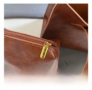 Detailed macro view of high-quality gold zipper and vintage oil wax leather texture