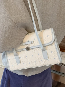 Blue and cream underarm bag with bear patterns, bow detail, and heart charm for women