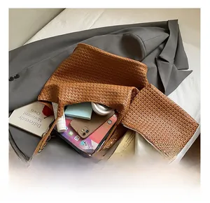 Detail view of woven brown tote bag interior showing large capacity for tablet and cosmetics