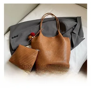 Detailed macro view of brown woven texture leather bucket bag with ball charms