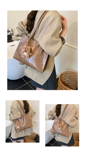 Detail of vintage brown tote bag with plush bear charm and premium stitching finish